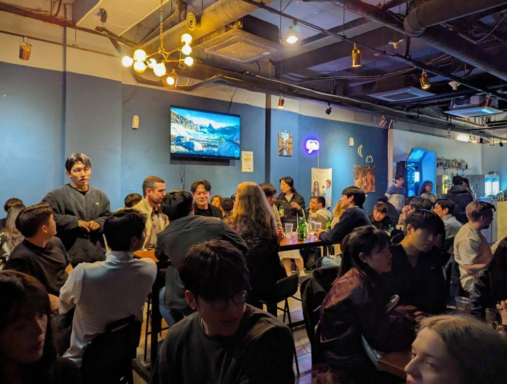 Local and international people meeting friends at GSM Tables Language Exchange pub in Gangnam