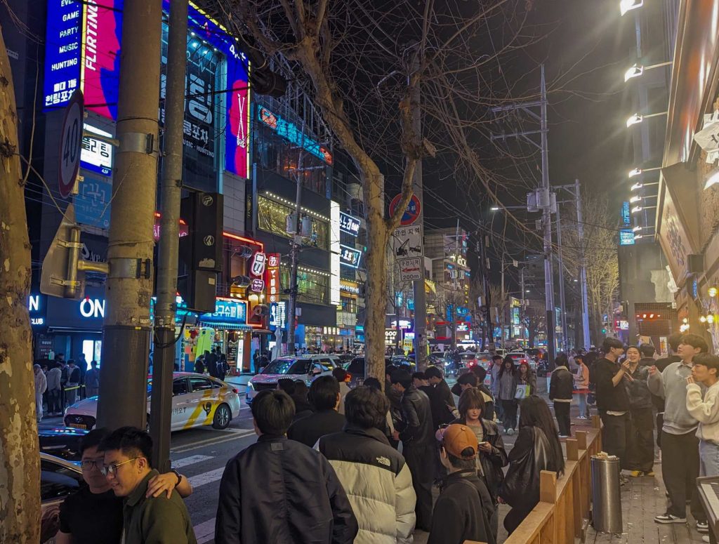 People standing on busy street in Hongdae