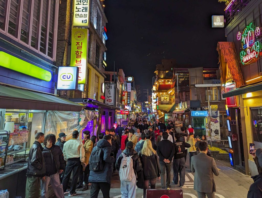 People chatting outside CU convenience store in Itaewon